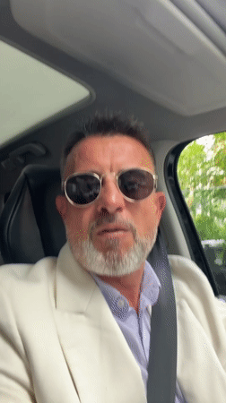 Well-dressed man observed in car driver's seat in Milan