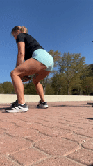 Woman performs weighted squats during morning workout in Montenegro