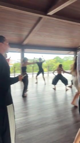 Early morning dance class held at wooden pavilion in Mengwi