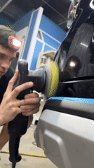 Auto shop workers perform detailing repairs in Krasnoyarsk garage