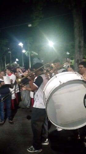 Nighttime religious procession with marching band in Tinaquillo, Venezuela