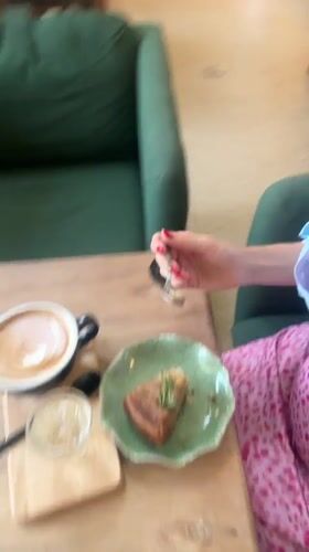 Woman enjoys morning coffee at Choeng Thale cafe