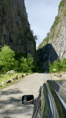 Car drives through narrow canyon near Inkiti, Abkhazia