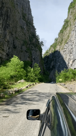 Car drives through narrow canyon near Inkiti, Abkhazia