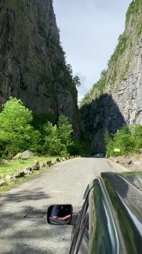 Car drives through narrow canyon near Inkiti, Abkhazia