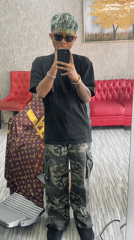 Green-haired person takes mirror selfie in Kuta, Indonesia