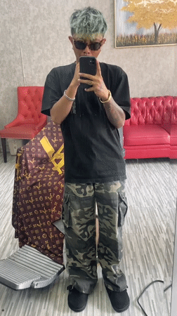 Green-haired person takes mirror selfie in Kuta, Indonesia