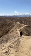 Solitary hiker spotted on ridge trail in Kyrgyzstan mountains