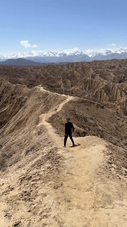 Solitary hiker spotted on ridge trail in Kyrgyzstan mountains