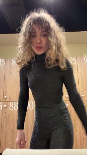Woman poses in sparkly jumpsuit at Moscow locker room