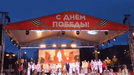 Children perform in white uniforms at Victory Day celebration