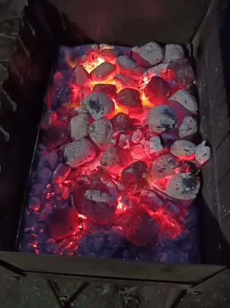 Evening barbecue in Biliaivka, coals glowing, steaks on the grill