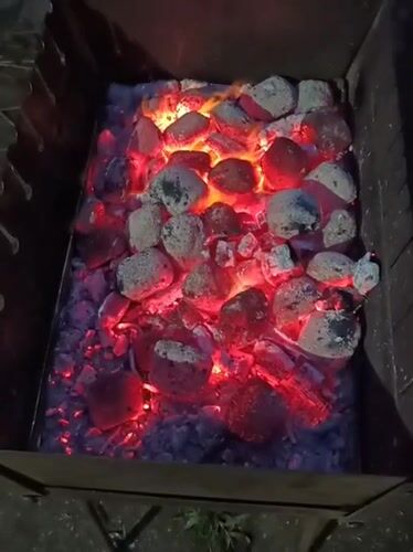 Evening barbecue in Biliaivka, coals glowing, steaks on the grill