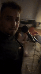 Man addresses microphone in string-lit Moscow venue