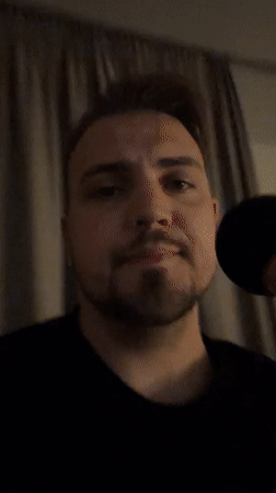Man addresses microphone in string-lit Moscow venue