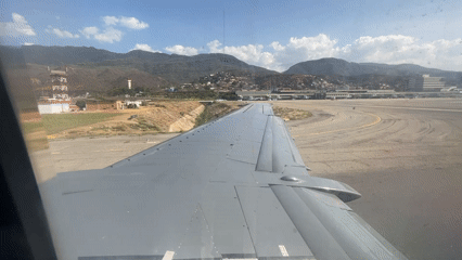 Passenger films aircraft wing view during tarmac stop Venezuela