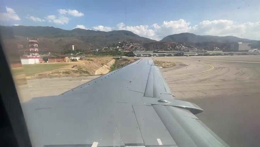 Passenger films aircraft wing view during tarmac stop Venezuela