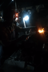 Evening street food vendors operate grills in Shangisha, Nigeria
