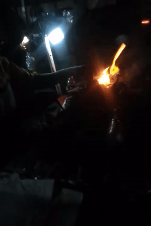 Evening street food vendors operate grills in Shangisha, Nigeria