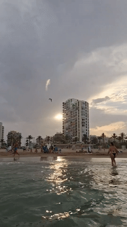 Alicante beach and promenade on a busy August afternoon