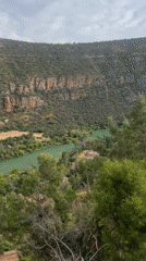 Visitor documents Bin El Ouidane Dam amid Moroccan mountain landscape