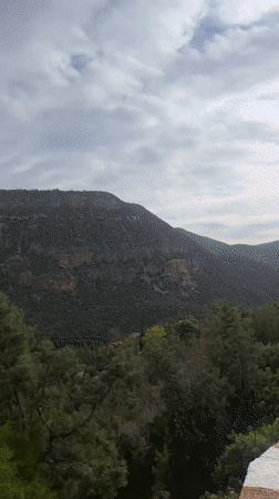 Visitor documents Bin El Ouidane Dam amid Moroccan mountain landscape