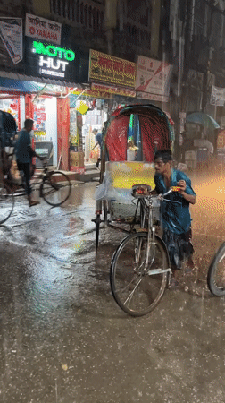 Rickshaw puller works through flood waters in Dhaka rain