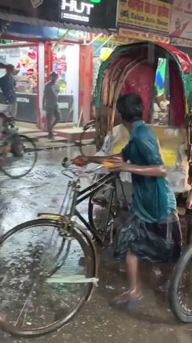 Rickshaw puller works through flood waters in Dhaka rain