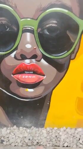Young people gather at mural-decorated outdoor cafe in Howayi
