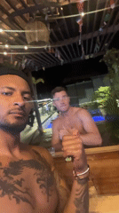 Three men take nighttime poolside selfie in Playa del Carmen