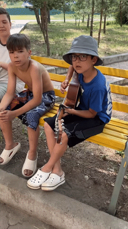 Guitar and singing on a park bench in Krasnoturansk