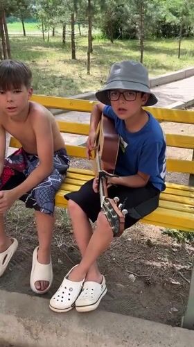 Guitar and singing on a park bench in Krasnoturansk