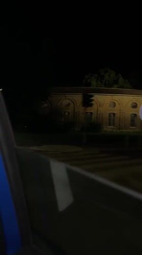 Nighttime street video captured from moving car in Milan