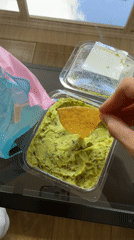 Londoner enjoys tortilla chips and guacamole snack