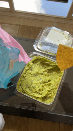 Londoner enjoys tortilla chips and guacamole snack