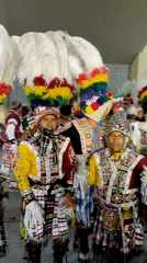 Men in traditional colorful costumes pose in Tacna Peru