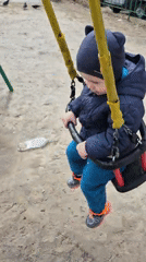 Toddler plays at colorful playground in Tobolsk morning