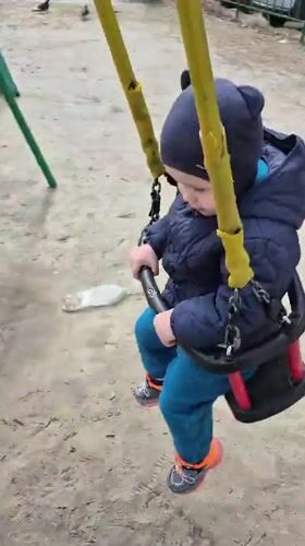 Toddler plays at colorful playground in Tobolsk morning