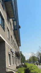 Window cleaner works on tall building in Vsevolozhsk