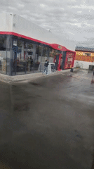 Bus stop moment near an Aktobe gas station convenience store