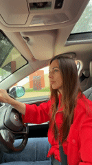 Woman in red jacket photographed with car in Birobidzhan