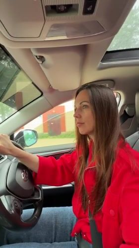 Woman in red jacket photographed with car in Birobidzhan