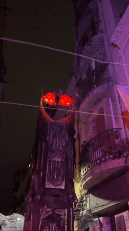 Themed nighttime event with lit sculptures and outdoor dining, Barcelona