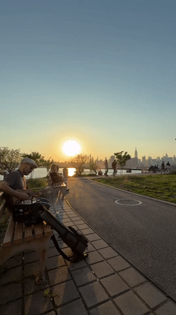 Sunset guitar performance and blooming flowers captured in NYC park