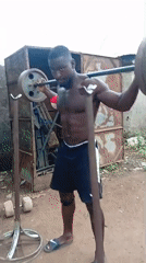 Man conducts outdoor weightlifting workout session