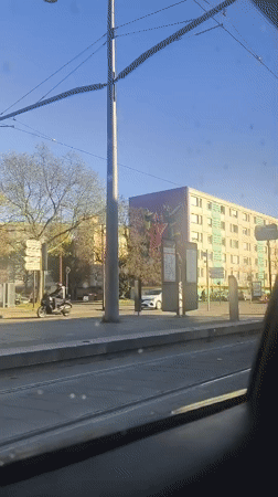 Daytime street scene recorded from moving tram in Bischheim