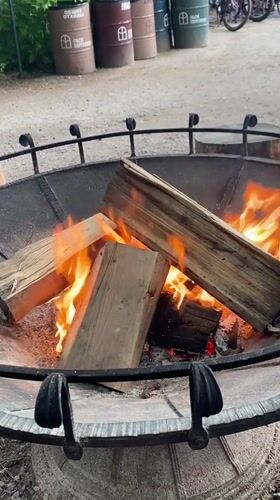 Rustic outdoor gathering spot with fire pits and greenery, Pargolovo