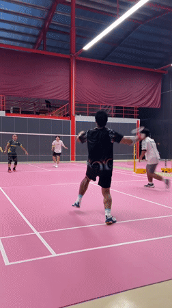 Badminton doubles match played on pink court in Ko Samui