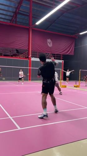 Badminton doubles match played on pink court in Ko Samui