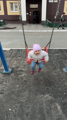 Toddler enjoys swing time at Tobolsk playground